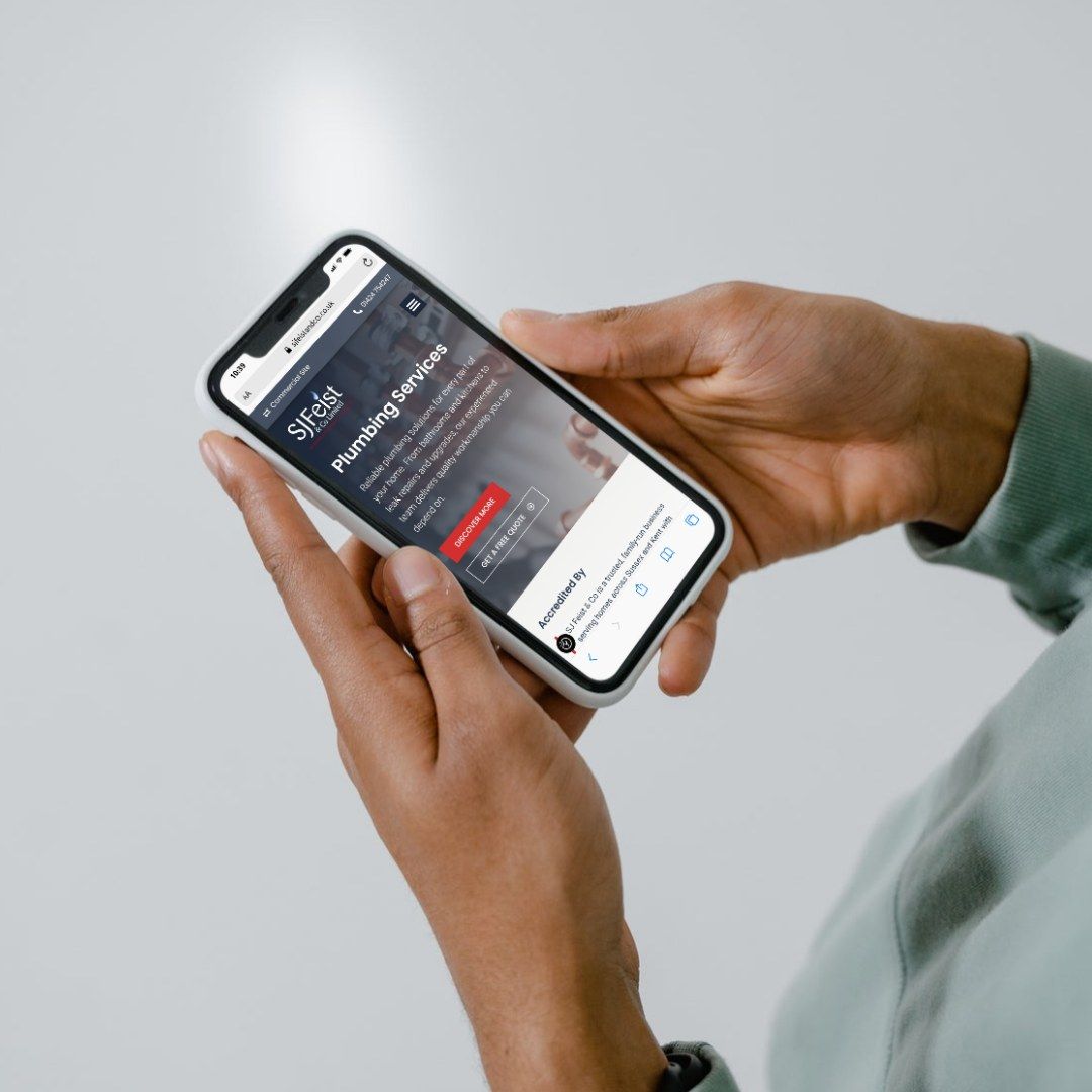 The SJ Feist & Co website on a phone in someone’s hand
